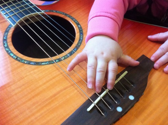 Taliah's Hand on My Acoustic Guitar